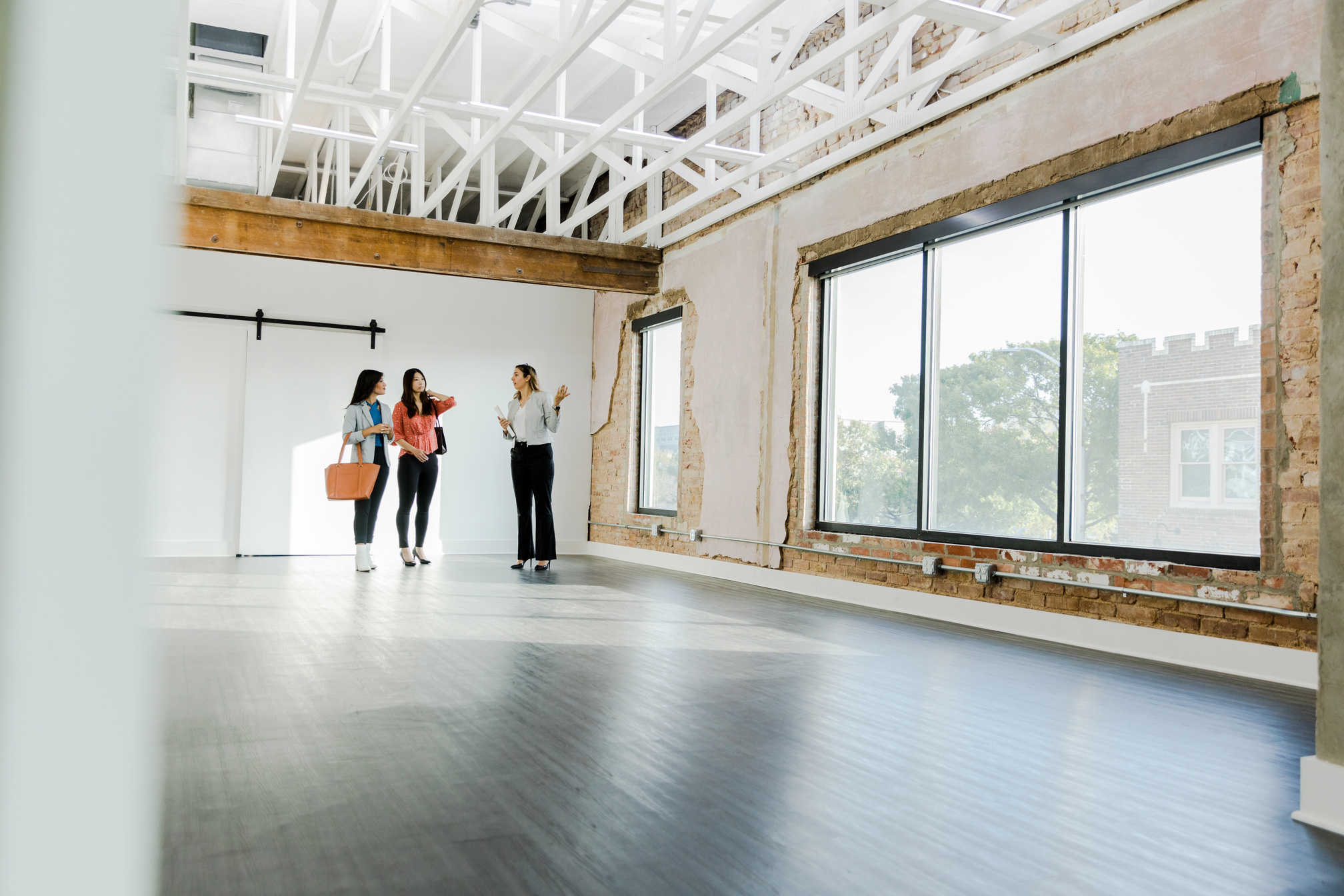 Female commercial Real Estate Agent shows office to female entrepreneurs